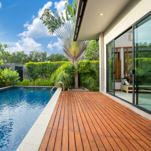 swimming pool and decking in garden of luxury home